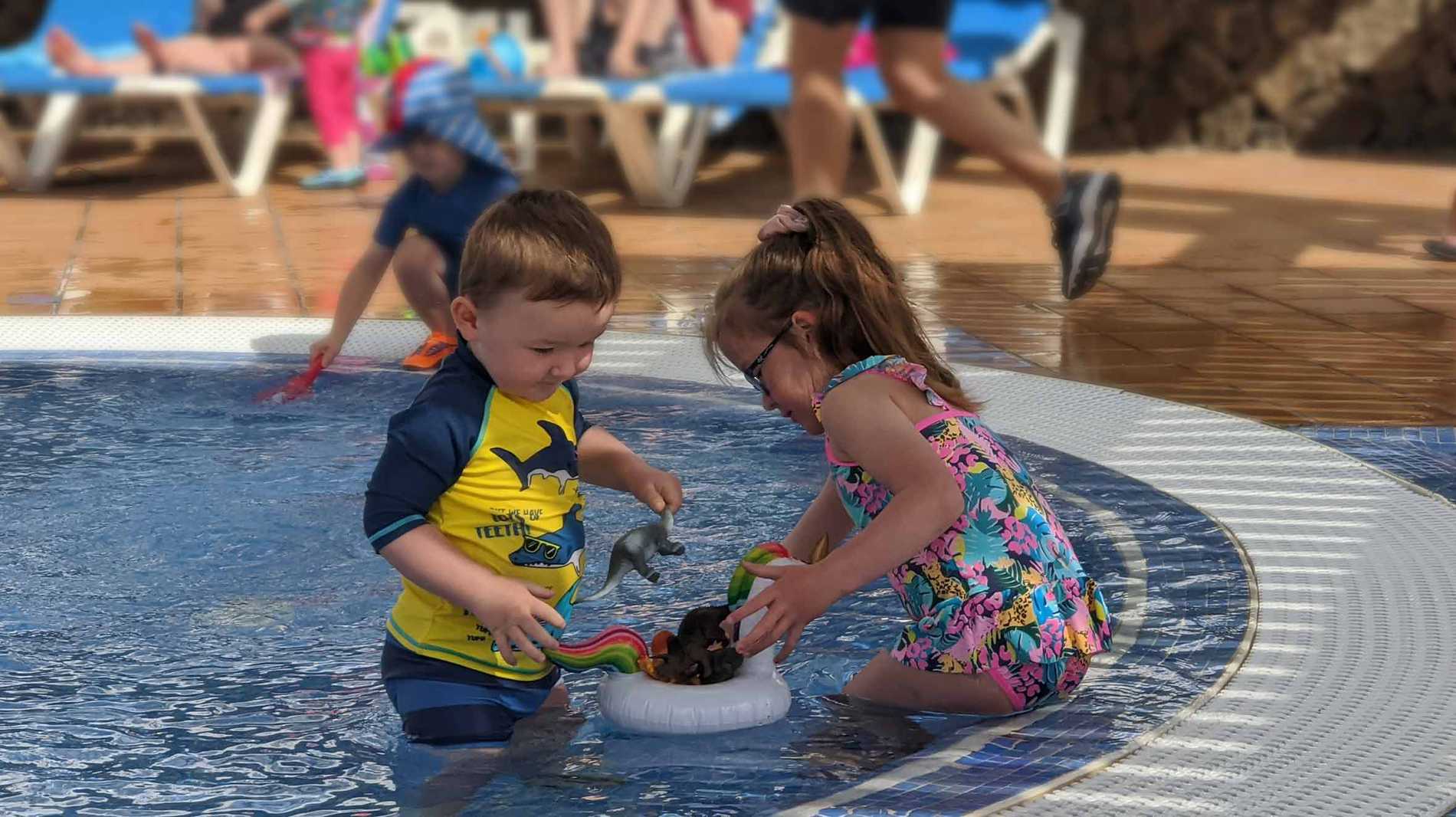 Hope and her brother paddling at the hotel during their holiday.