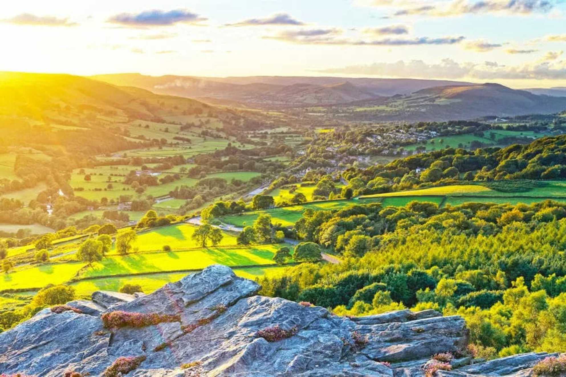 A panoramic view of the Peak District countryside at sunset.