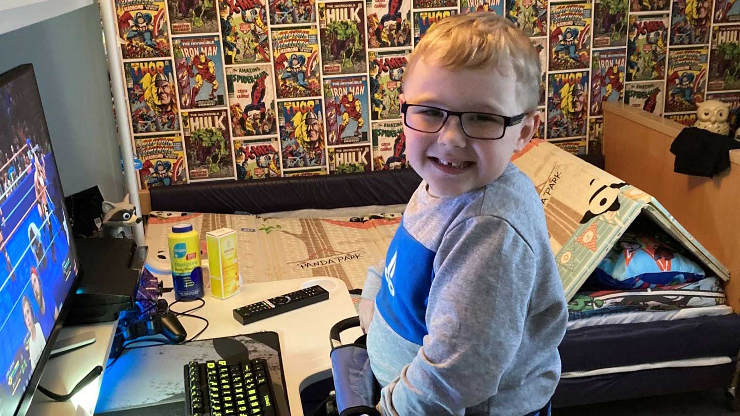 A smiling Harrison in front of his new gaming PC.