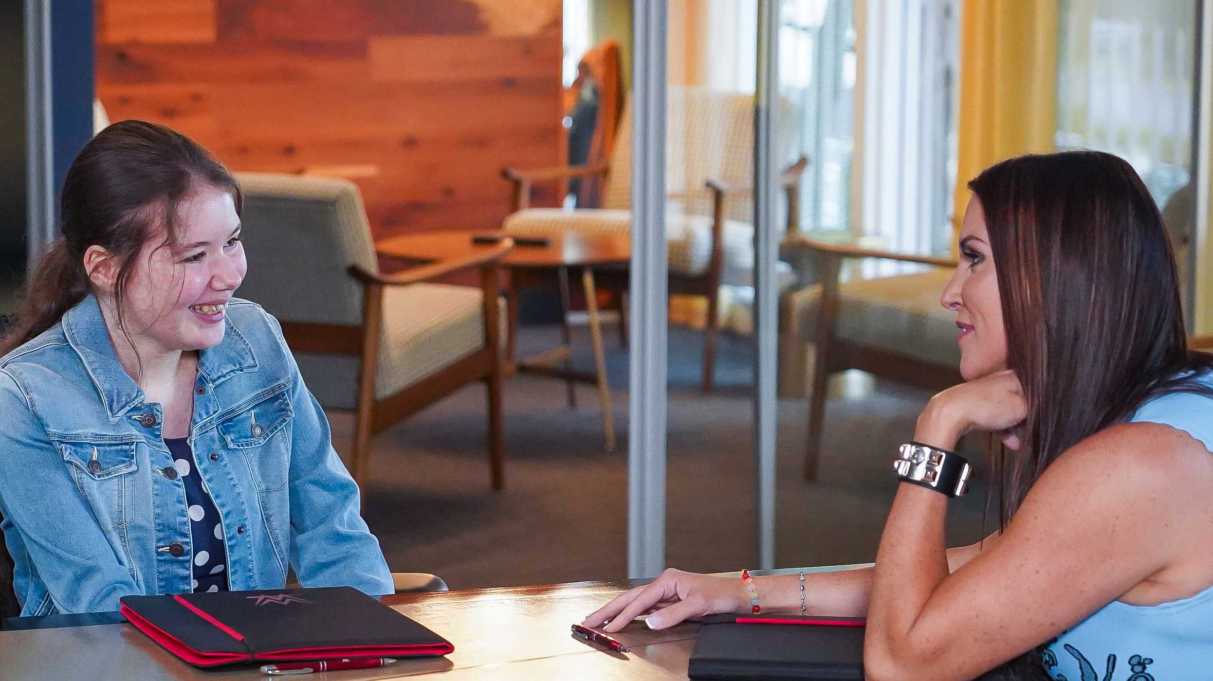 Rhianna discussing her ideas with Stephanie McMahon