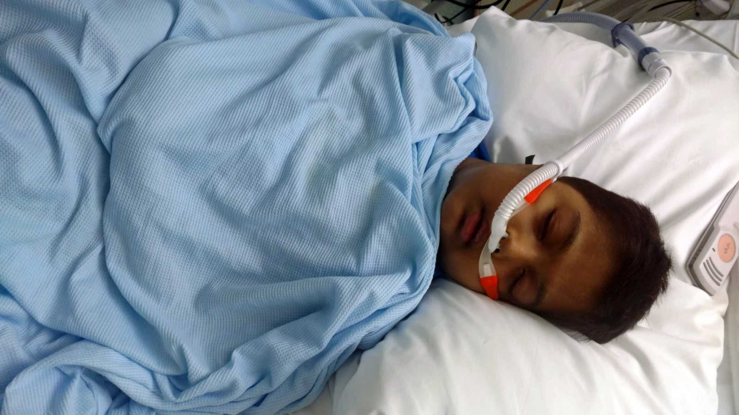 Abhi lying in a hospital bed during treatment for his condition.