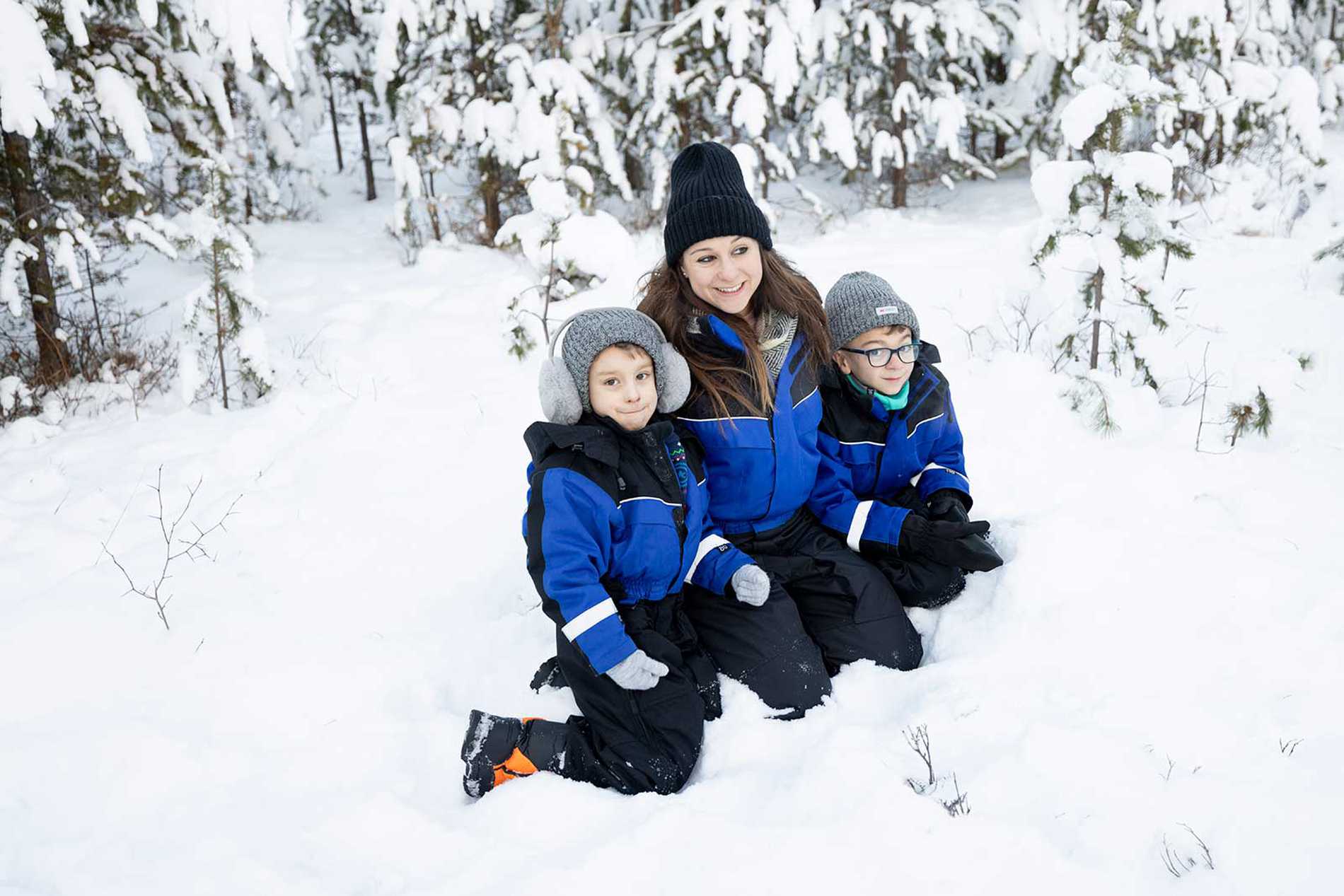 A group shot of mum and the children against a snowy backdrop.