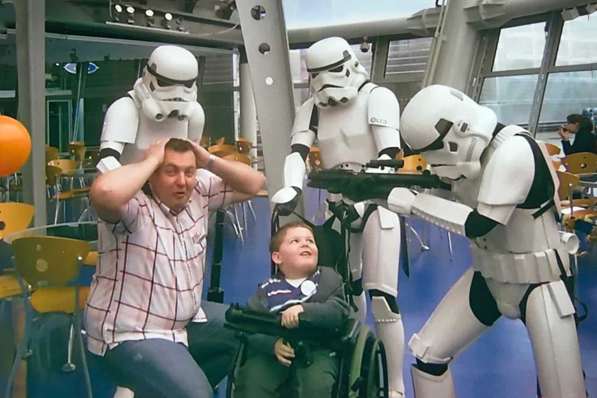 Jacob and his dad surrounded by Stormtroopers during his wish.