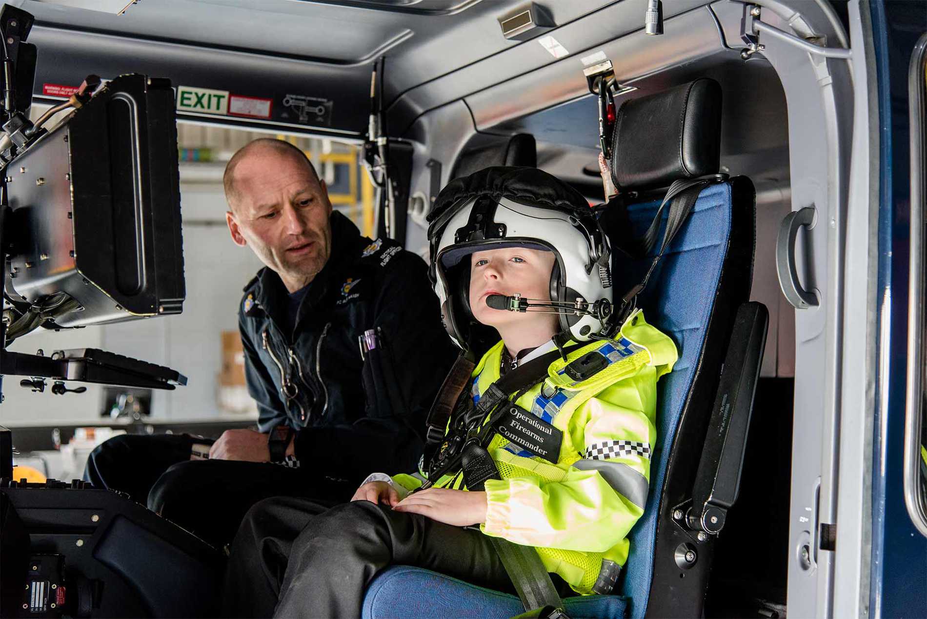 Allan being shown the controls of a police helicopter.