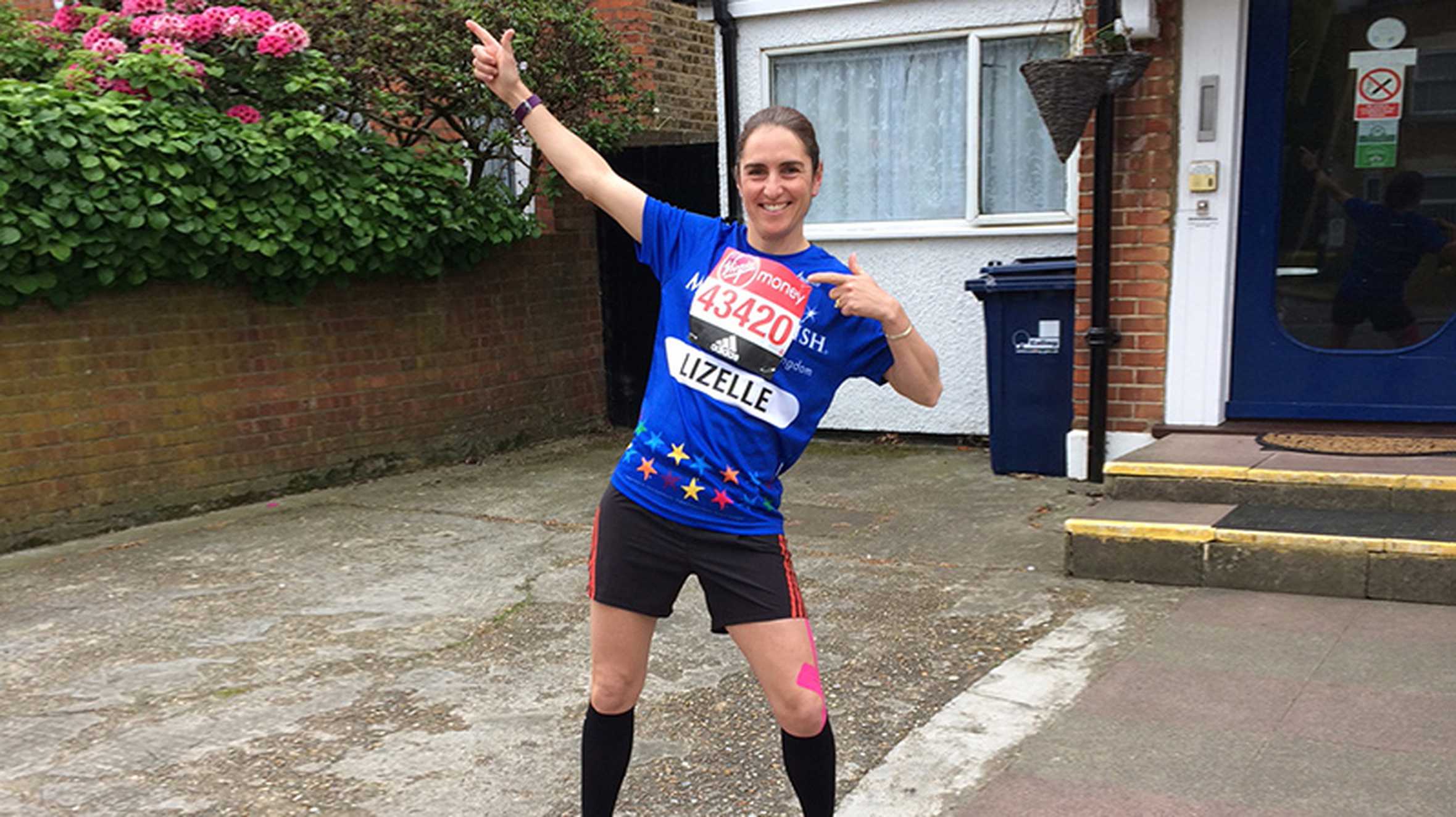 Lizelle outside her house in her running gear, ready to take on the London Marathon.