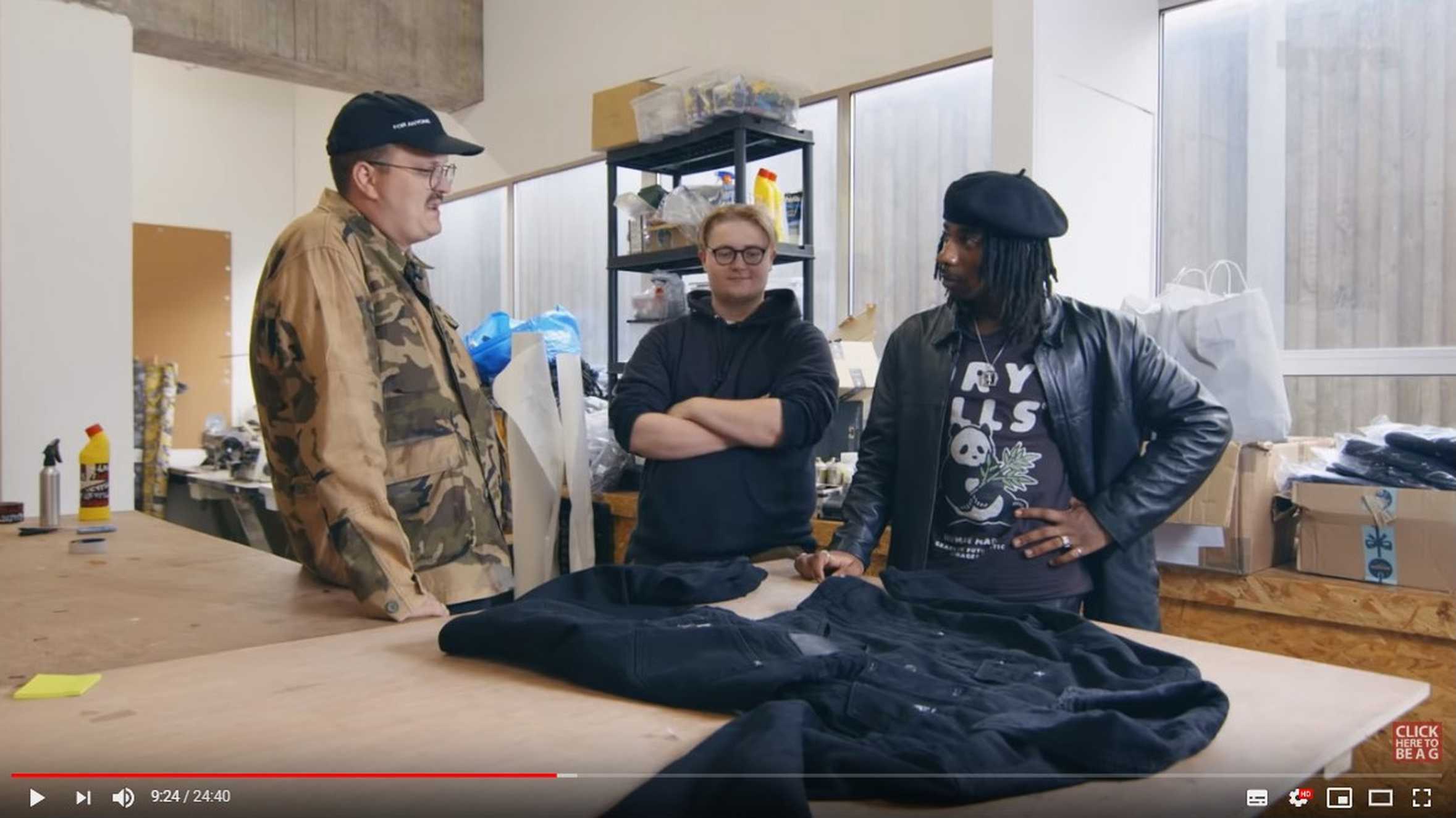 Xavier and one of the PAQ crew talking to a designer in his studio