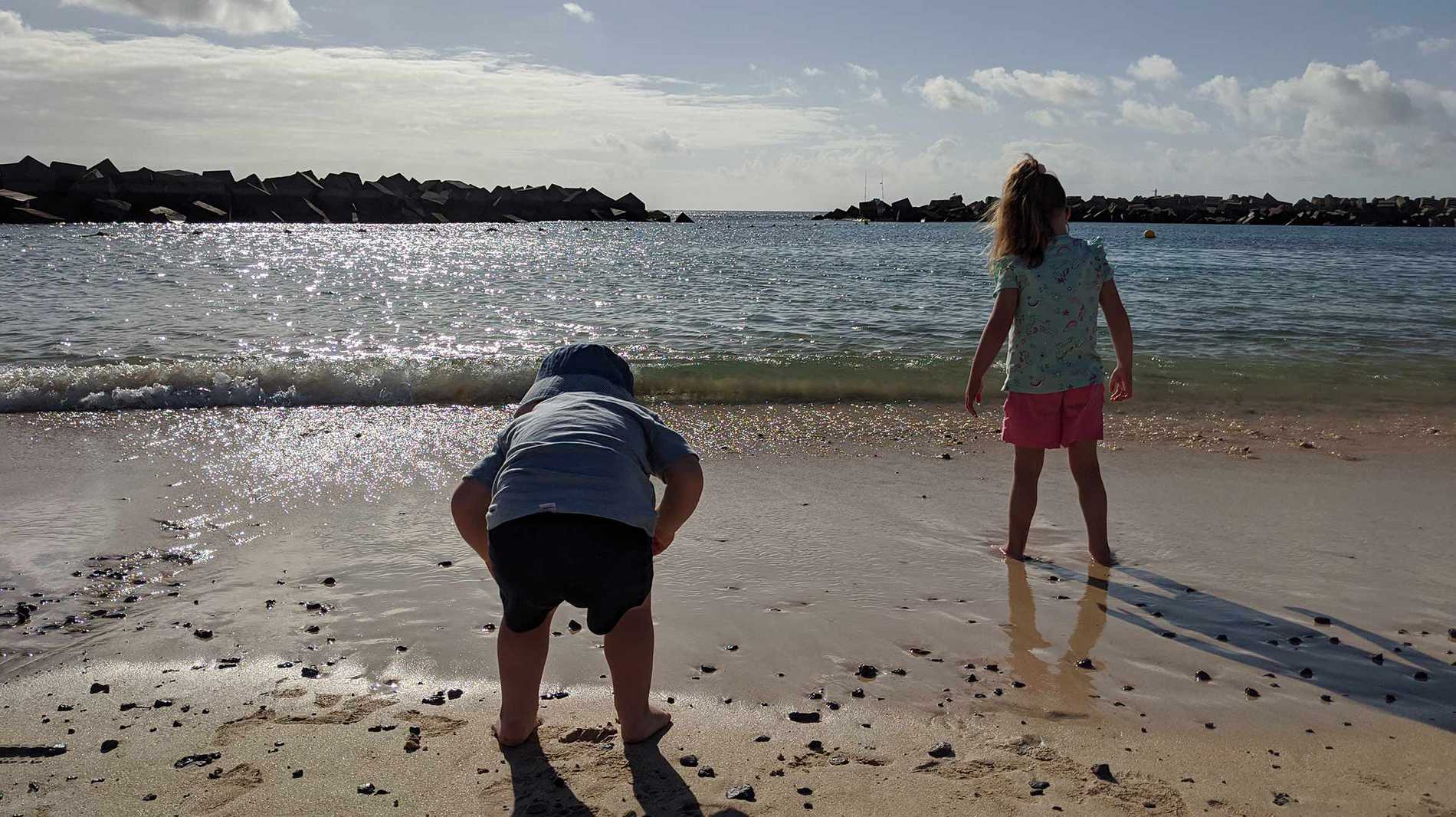 Hope and her brother paddling in the sea during her wish.