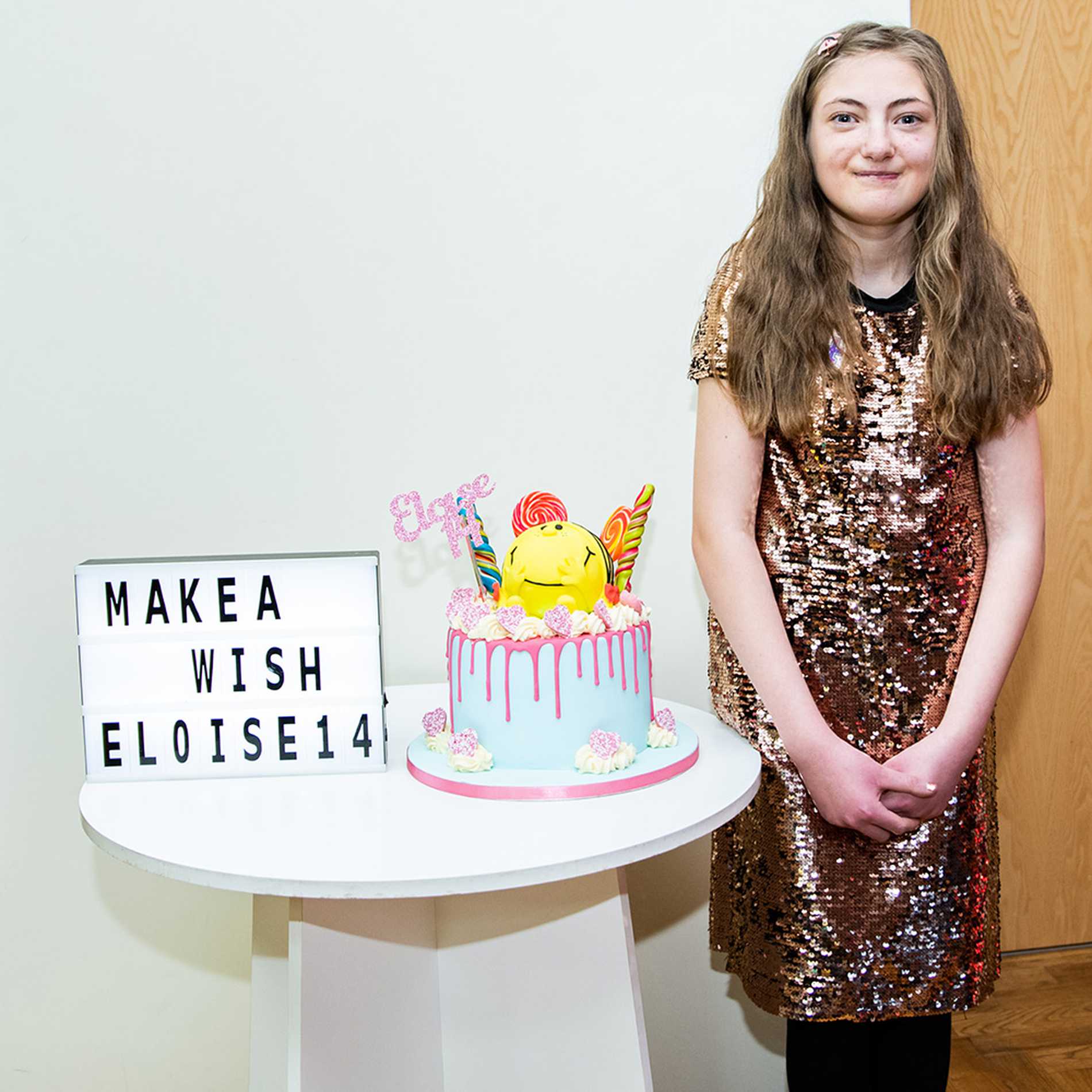 Eloise standing by her Mr Men-themed birthday cake.