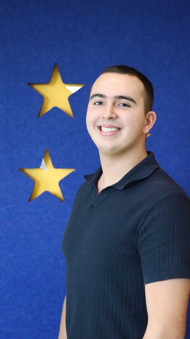 STARboard member Darshan is smiling looking into the camera, he is wearing a blue polo shirt.