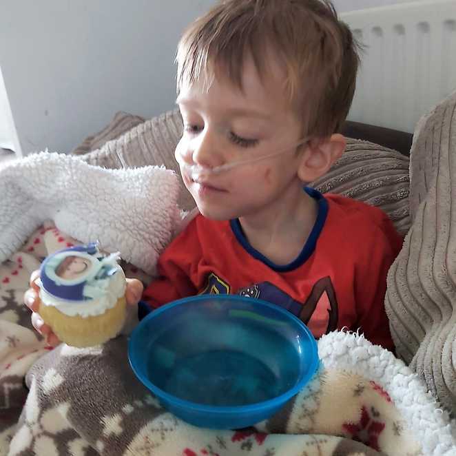 Aiden enjoying one of his space-themed cupcakes.