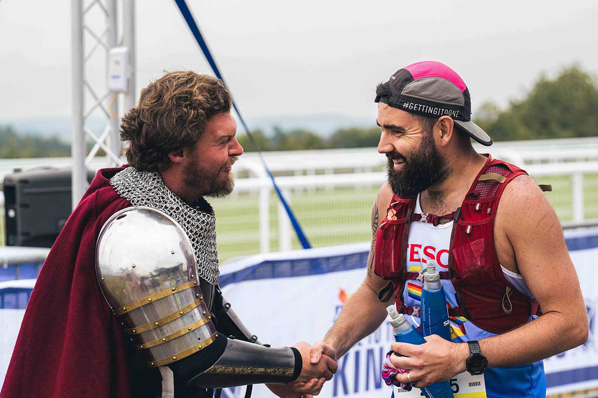 A participant shaking hands with a king after completing the race.