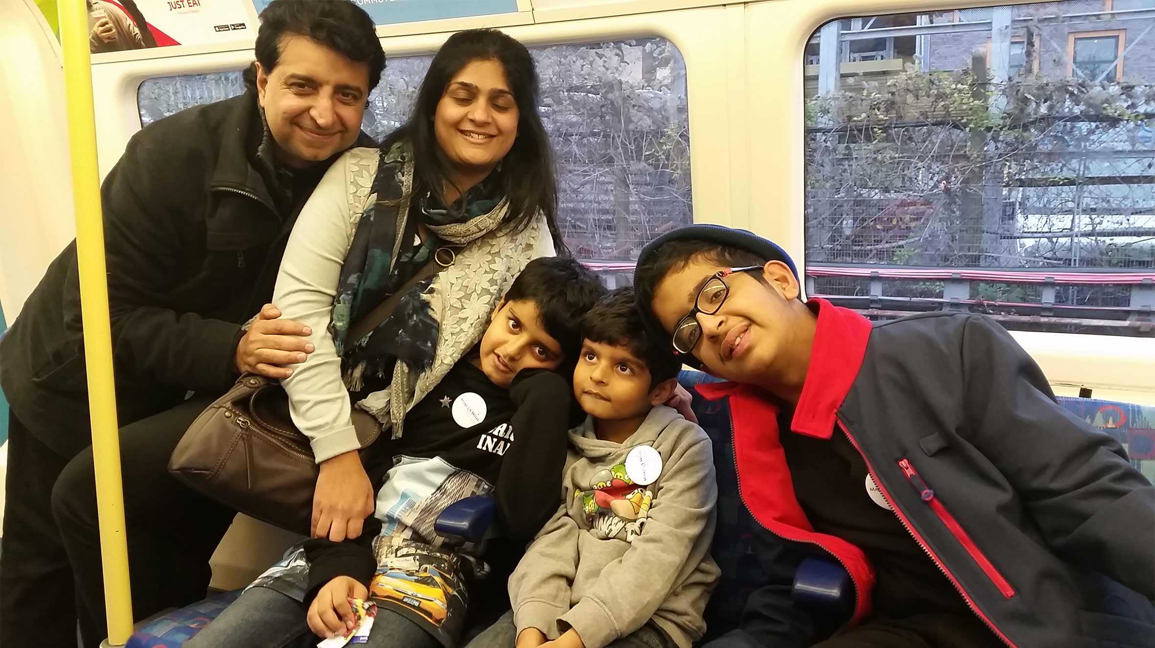 Krish and his family sat together on the tube.