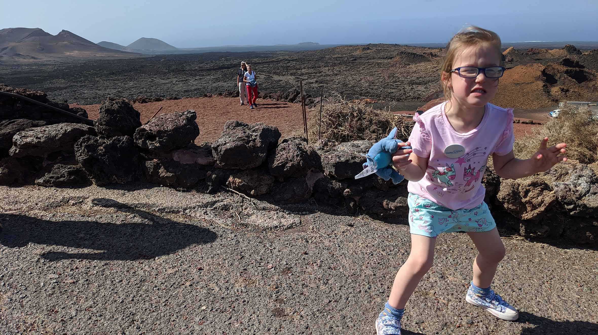 Hope during her trip to see see a volcano, with rugged scenery in the background.