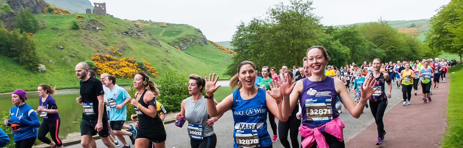 Runner enjoying the spectacular scenery on the Edinburgh Marathon route