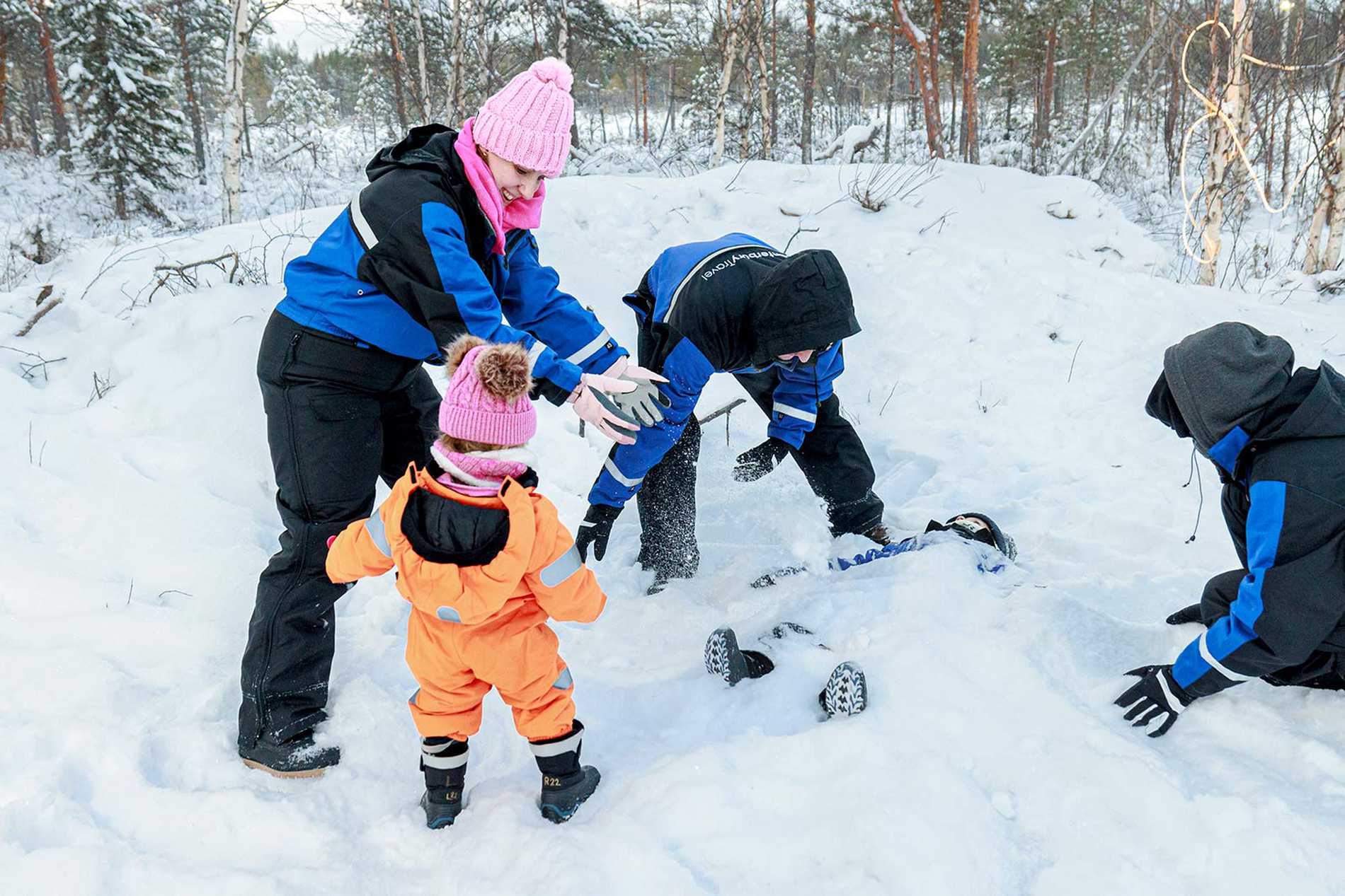 James' family having fun burying him in the snow.