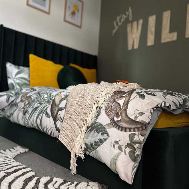 Joshua's new bed, complete with jungle themed duvet set, and a wall decal saying 'stay wild'.
