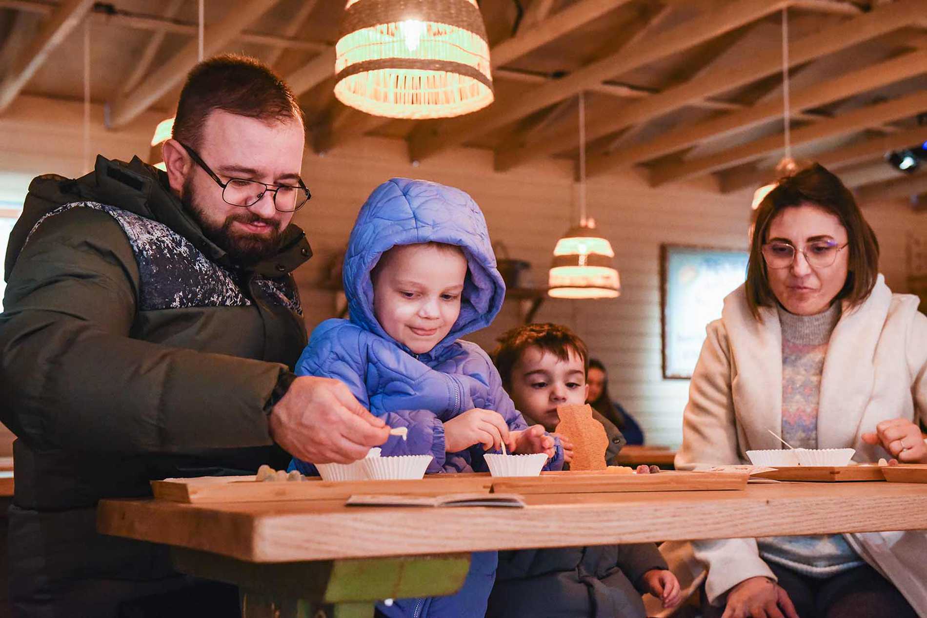 Julia eating lunch in the kitchen at Lapland UK with her family.