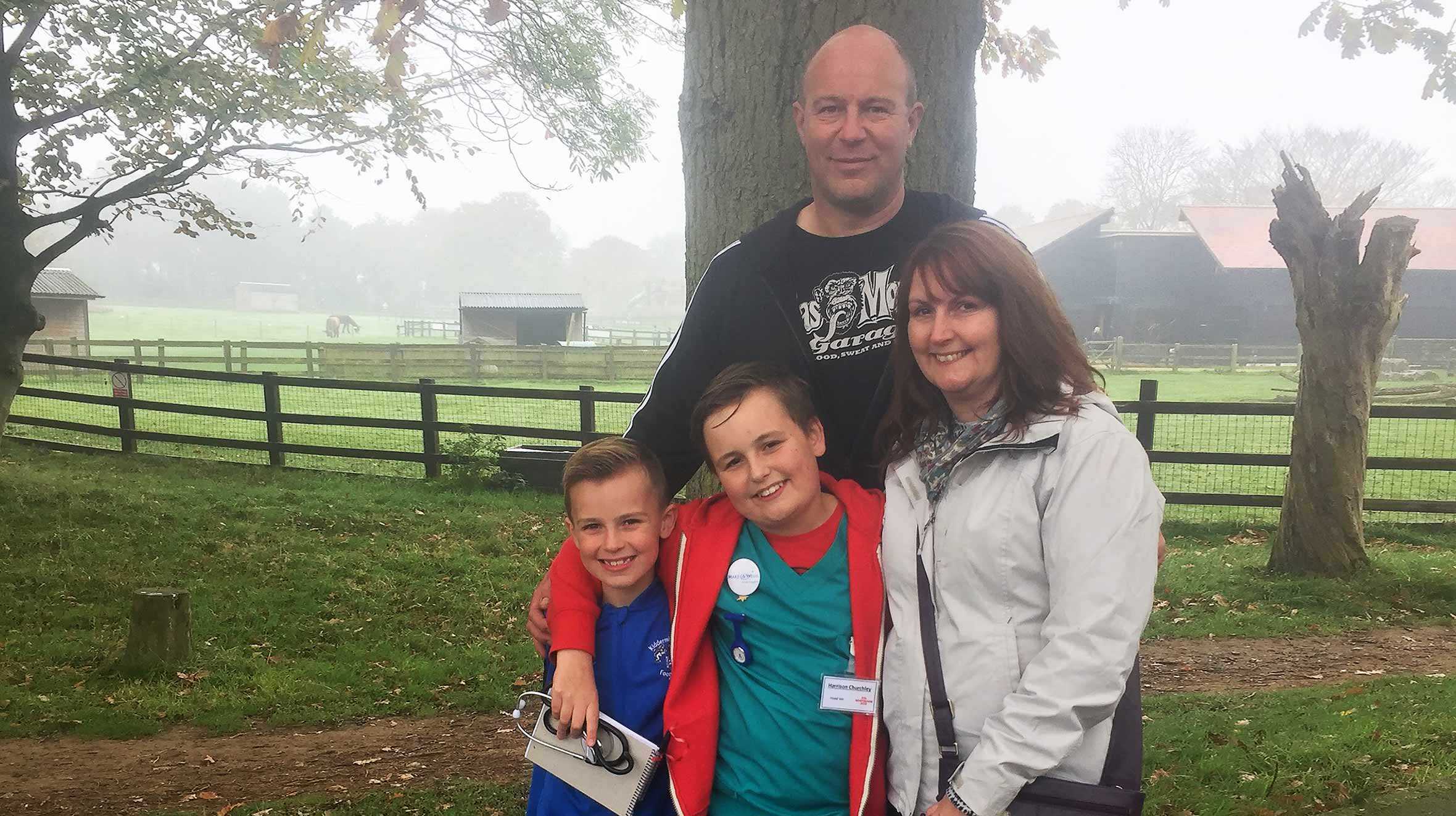 Harrison and his family posing in a glade of trees at Whipsnade Zoo during his wish.