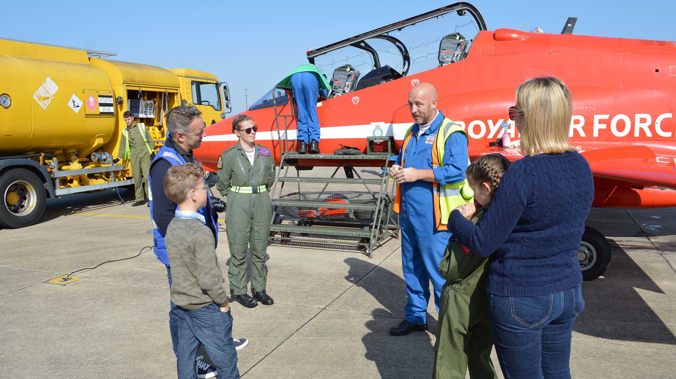 John and his family talking to a member of the ground crew with a Red Arrows jet in the background.