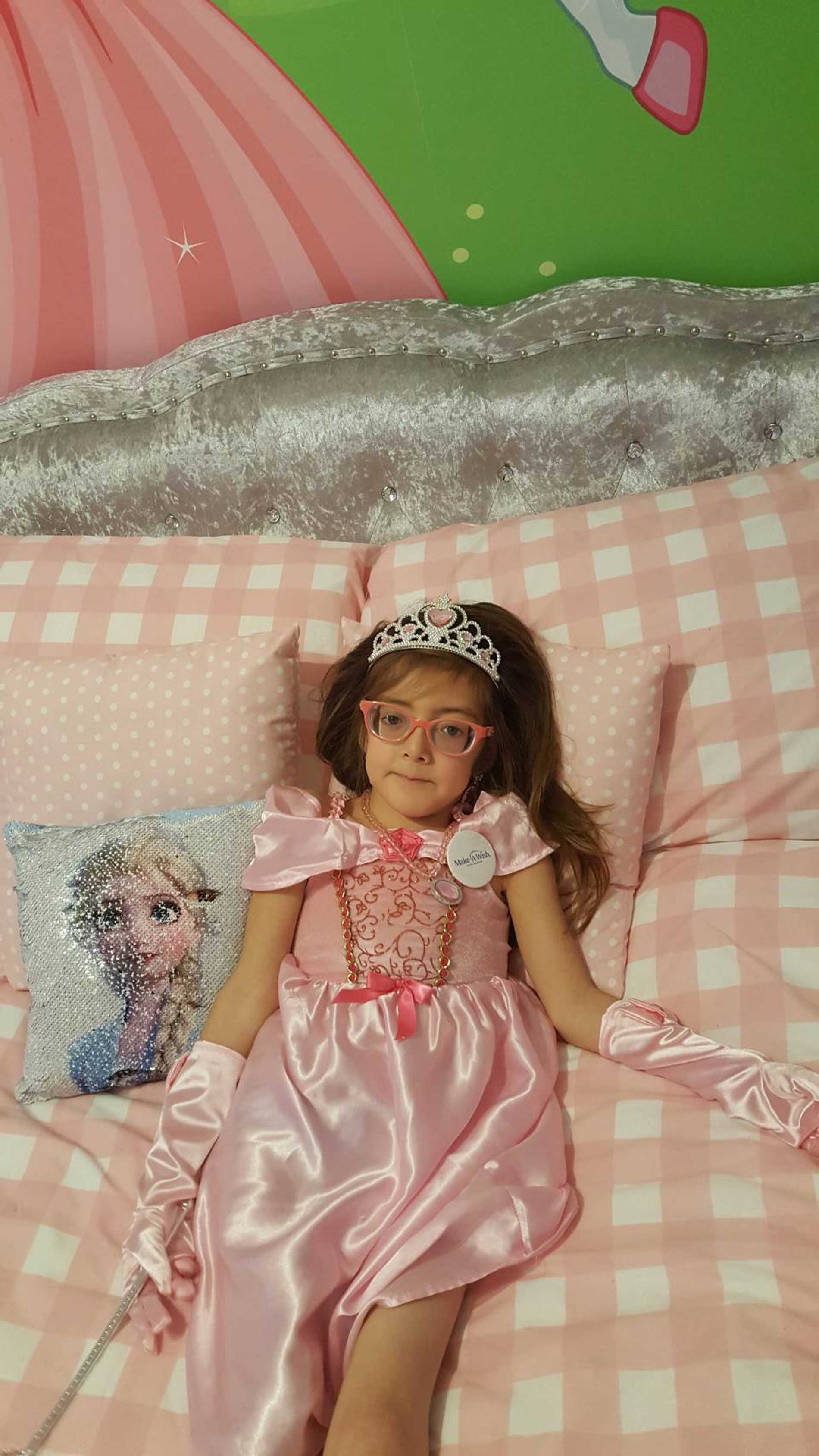 Smiling wish child, Tiara in her princess-themed bedroom.