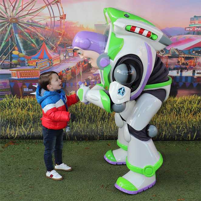 A smiling Archie meeting Buzz Lightyear from Toy Story.