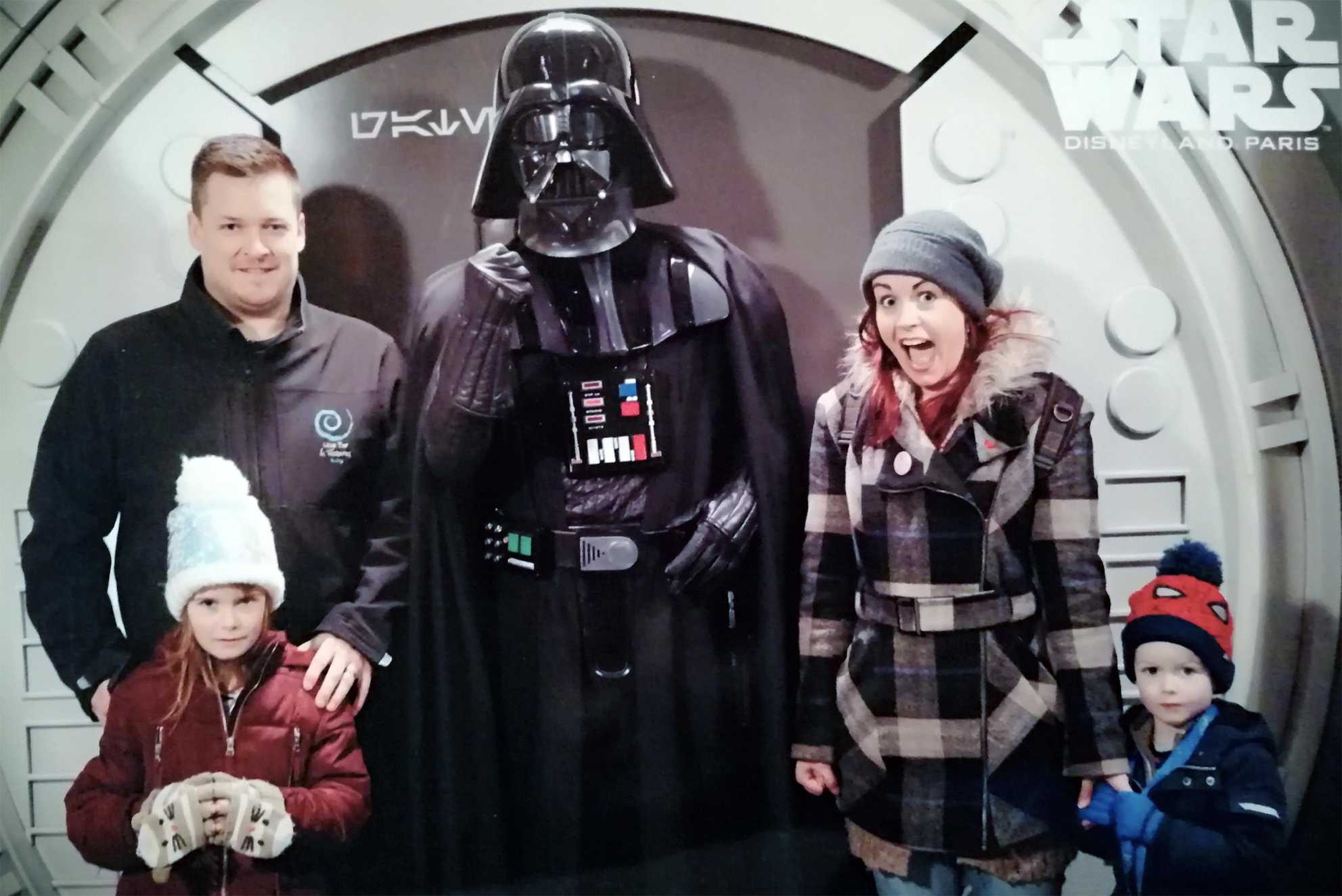 Ezekiel and family standing with Darth Vader