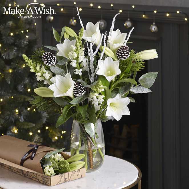White lilies arranged in a glass vase.