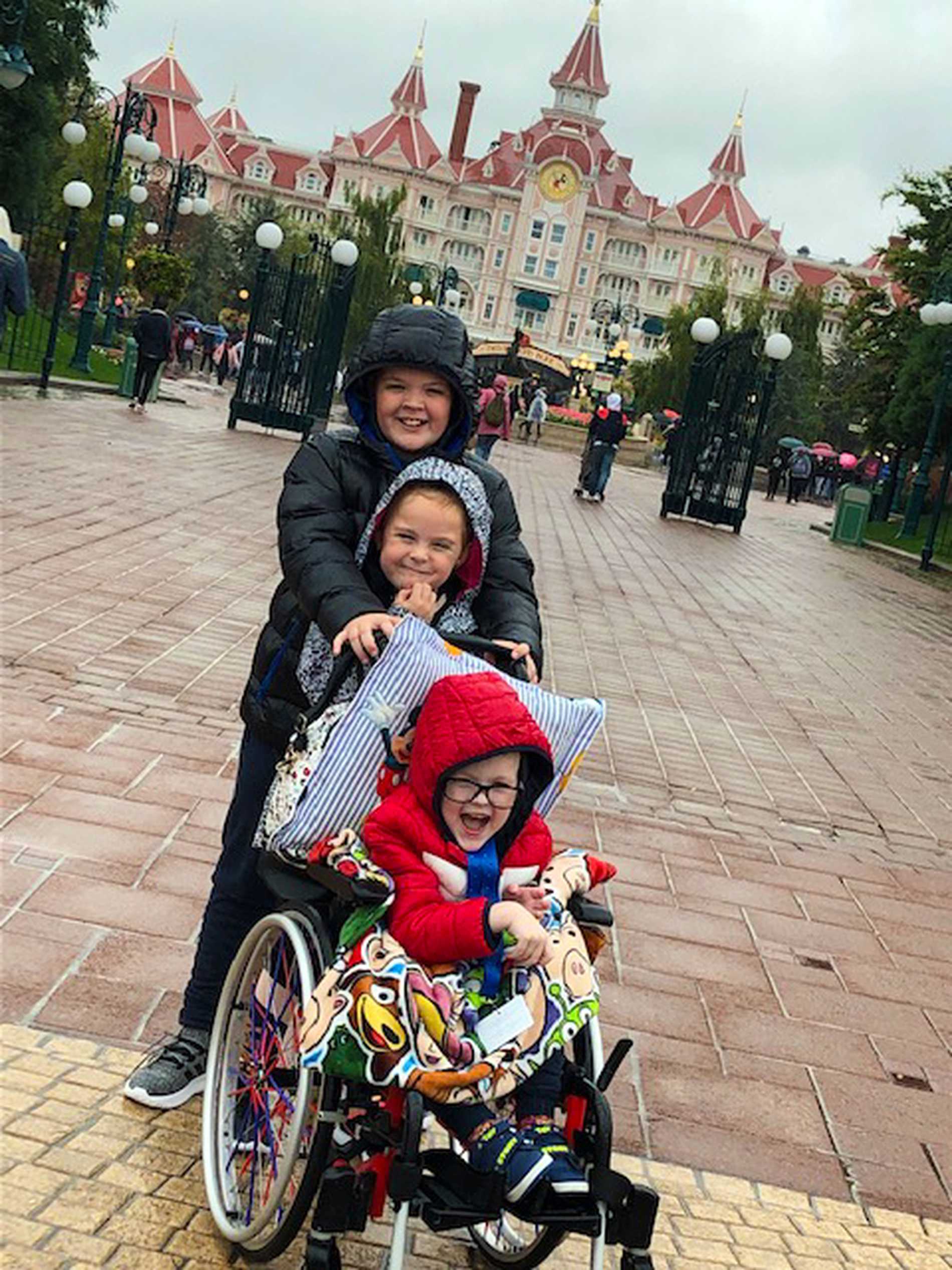 Patrick with his brother and sister, in front of their hotel.