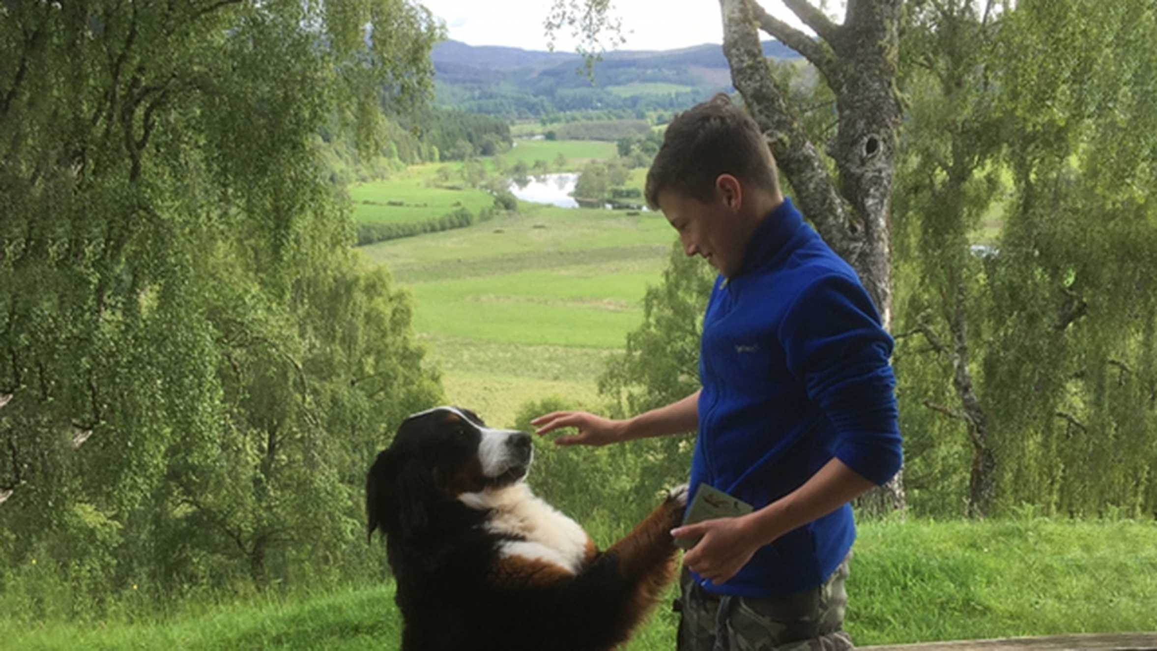 Wish child Brandon with a dog on his wish in the Scottish Highlands