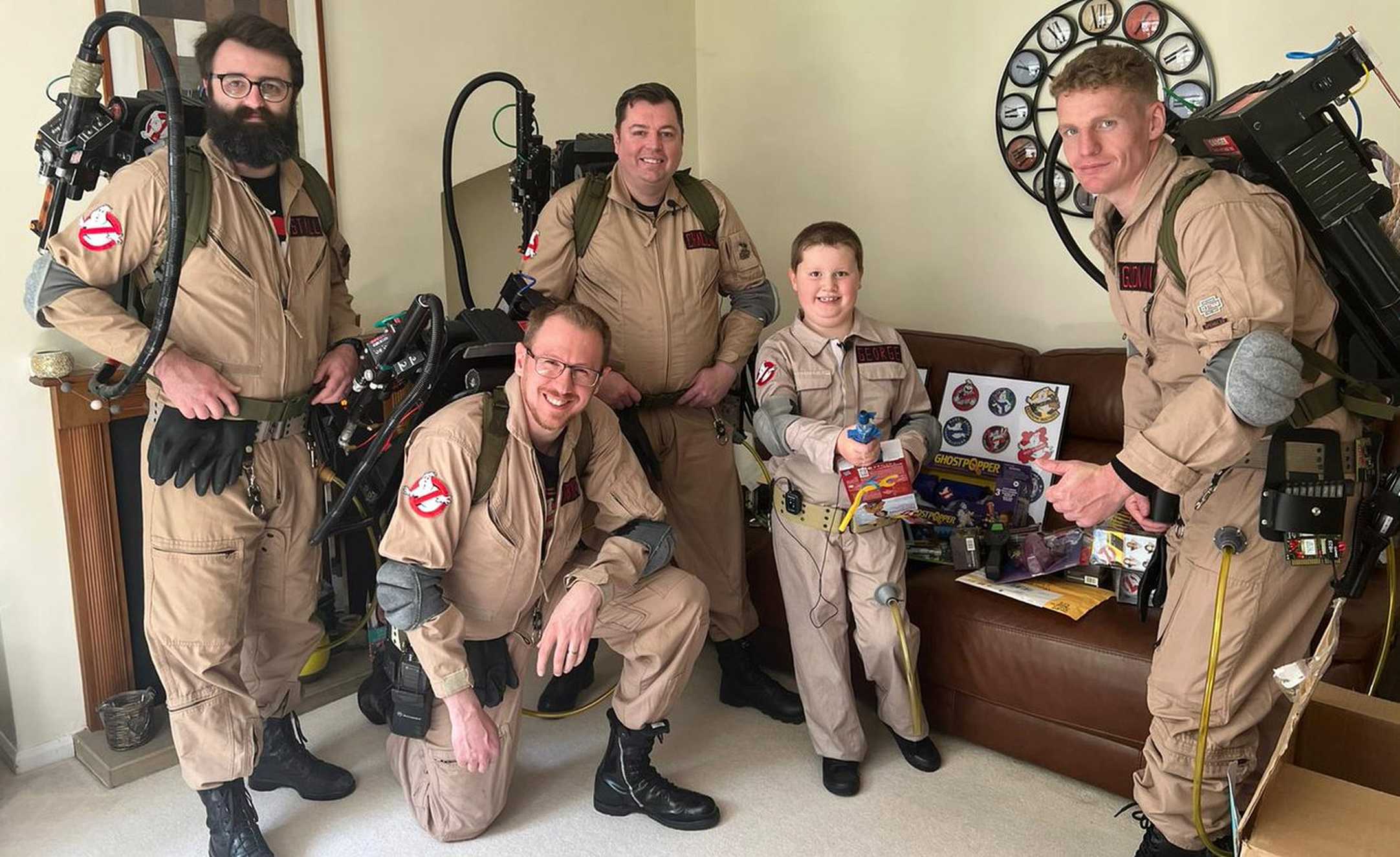 George with his fellow Ghostbusters posing in his front room.