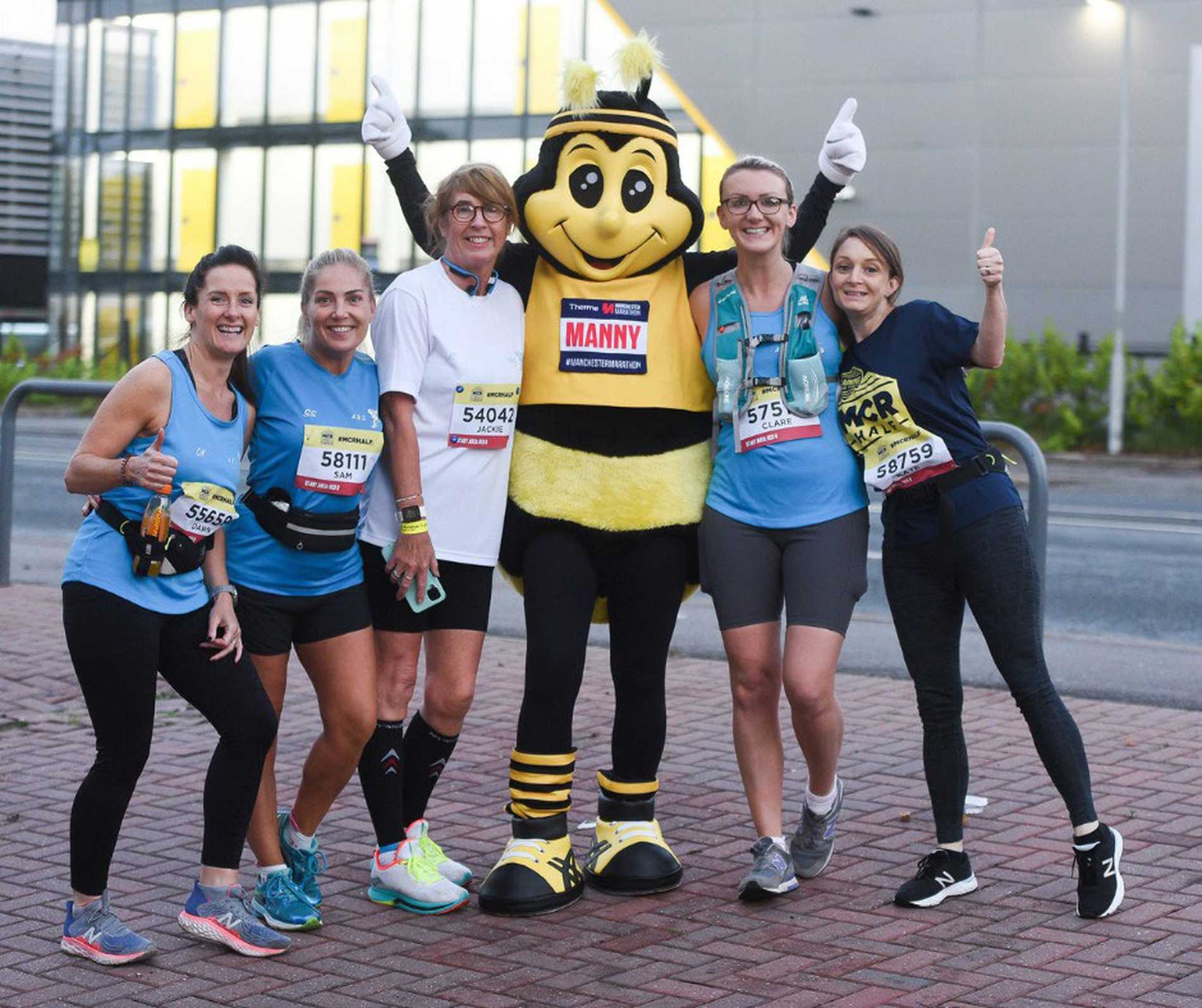 A group of Manchester half runners, including one wearing a bee costume.